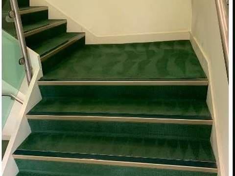 After: freshly steam-cleaned green carpeted stairs