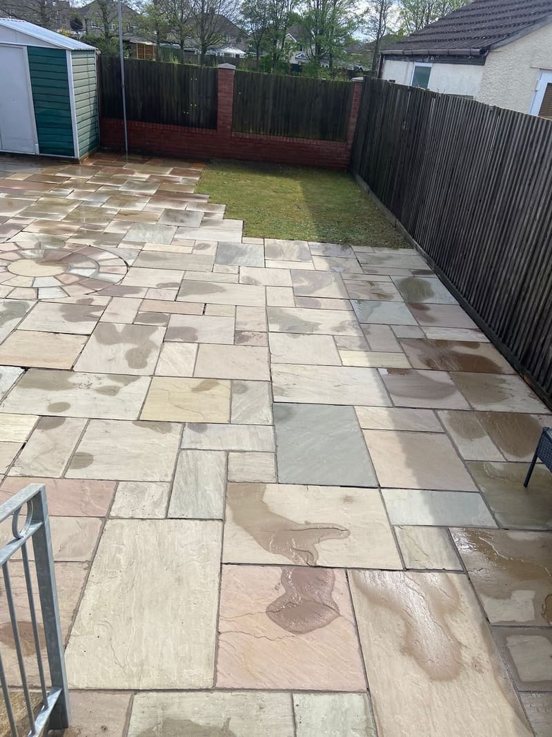 After: cleaned sandstone patio with circular design