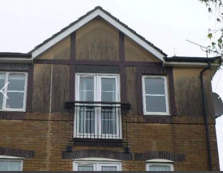 Before: discoloured render and brickwork on a house exterior