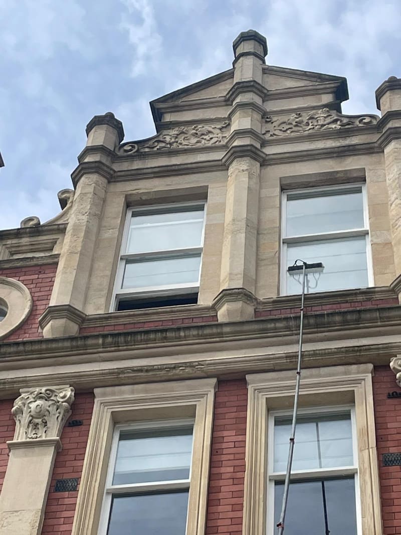 Water-fed pole reaching the upper floor of a stone building