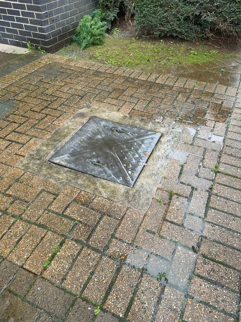 Drain cover on wet brick pavers during drain jetting